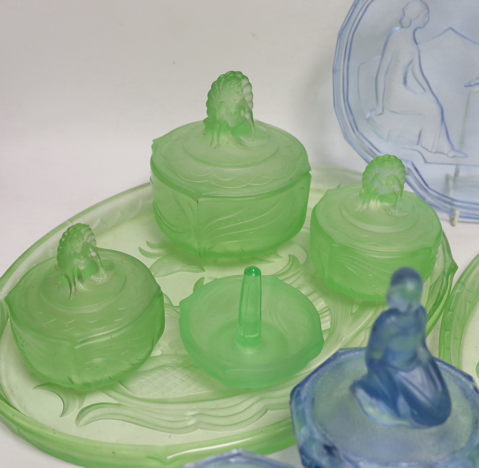 Walther & Sohne, moulded glass dressing table sets including three trays, lidded jars, etc., largest tray 35.5cm